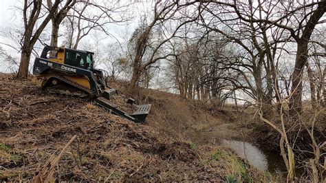 how to clear land with a skid steer|skid loader moving tree video.